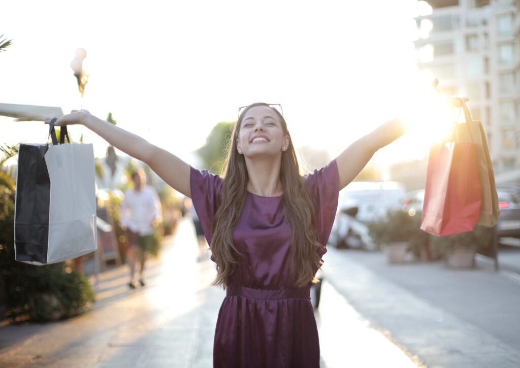 woman in purple dress raising her hands